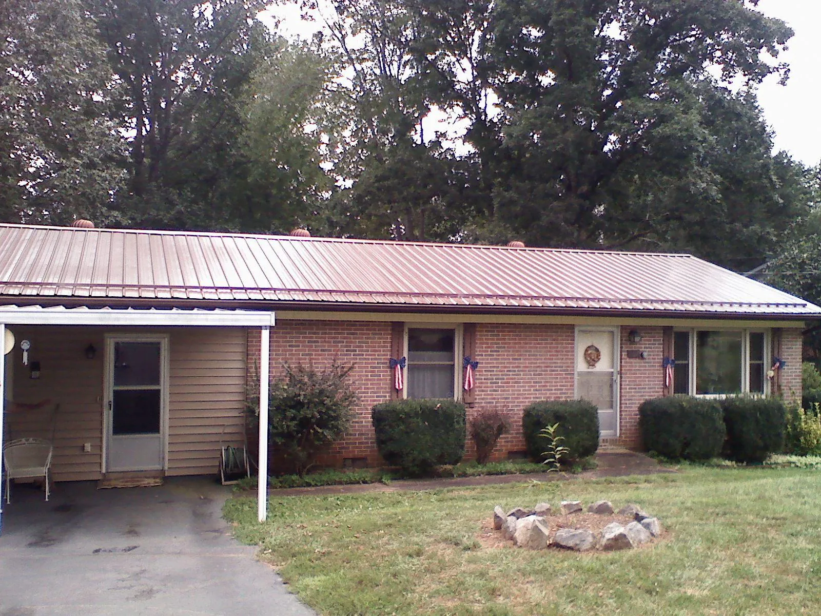 Bronze metal roof and carport on a brick ranch home — Roof Repair work by our crew in Culdesac